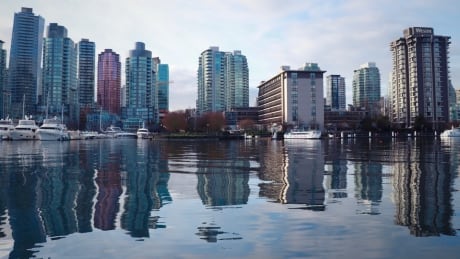 The towers around Vancouver's Coal Harbour reflect in the water. Vancouver