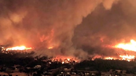 This July 26, 2018 file image taken from video released by Cal Fire shows a fire tornado over Lake Keswick Estates near Redding, Calif. A new study says a rare fire tornado that raged during the deadly wildfire this summer in Northern California was created by a combination of scorching weather, erratic winds and an ice-topped cloud that towered miles into the atmosphere. The study announce Wednesday, Dec. 5, 2018, in the Geophysical Research Letters journal used satellite and radar data to suggest how a monstrous "firenado" the size of three football fields developed on July 26. California Wildfire Fire Tornado