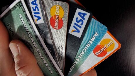 In this March 5, 2012, file photo, consumer credit cards are posed in North Andover, Mass. Statistics Canada says the ratio of household credit market debt to disposable income edged down in the first quarter. Statcan Household Debt 20160614