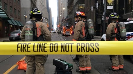 Firefighters stand by their equipment after a bomb threat evacuated the King Street subway station in downtown Toronto, Thursday, Dec. 13, 2018. THE CANADIAN PRESS/Graeme Roy Toronto Bomb Threat 20181213
