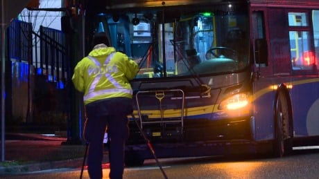 RCMP collision investigators photograph the scene where the woman was hit by a transit bus. BURNABY BUS FATAL CRASH