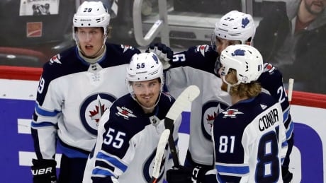Winnipeg Jets centre Mark Scheifele (55) is congratulated by teammates after scoring his goal against the Chicago Blackhawks. jets-blackhawks