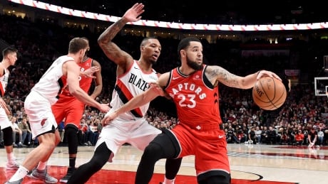 Toronto Raptors guard Fred VanVleet, right, tries to get past Portland Trail Blazers guard Damian Lillard, left, during the first half. raptors-blazers