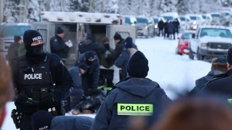 RCMP officers massed on a remote road in northern B.C. before arrests at a Unist'ot'en barricade January 7. Police at Gidimt'en Jan. 7