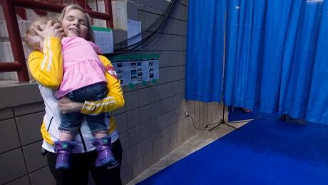 Jennifer Jones takes a moment to comfort her then two-year-old daughter at the 2015 Scotties Tournament of Hearts. CUR Scotties 20150219 TOPIX