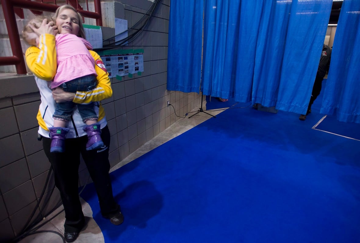 A woman holds her child.