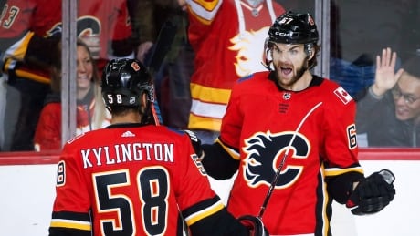 Calgary Flames' Michael Frolik, right, celebrates his goal with teammate Oliver Kylington during the second period. panthers-flames