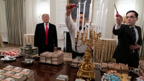 U.S. President Donald Trump surveys a feast of fast food to be served to the Clemson Tigers at the White House in celebration of their national football championship at the White House on Monday. ck04.jpg
