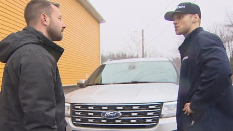 A Clutch "concierge" explains a vehicle's features to potential buyer Trevor Bergmann. Bergmann chose the car on the Clutch website and had it delivered to his workplace for a test drive. Halifax