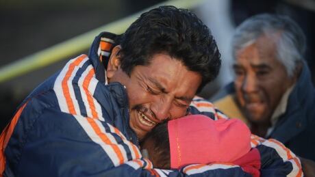 TLAHUELILPAN, MEXICO - JANUARY 19: Family members of a victim cry when recognizing the body after an explosion in a pipeline belonging to Mexican oil company PEMEX on January 18, 2019 in Tlahuelilpan, Mexico. In a statement, PEMEX announced that the explosion was caused by the illegal manipulation of the pipeline, as minutes before the accident videos were shot where people could be seen filling drums and car fuel tanks. (Photo by Hector Vivas/Getty Images) hv1_0994.jpg