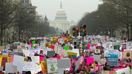 Demonstrators hold signs on Pennsylvania Avenue during the Women's March in Washington on Saturday, Jan. 19, 2019. Womens March Washington