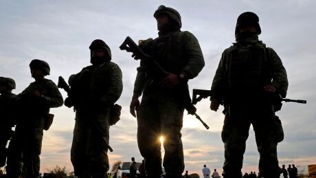 EDITORS NOTE: Graphic content / Mexican soldiers stand guard at the site of a massive blaze triggered by a leaky pipeline in Tlahuelilpan, Hidalgo state, Mexico on January 19, 2019. - An explosion and fire has killed at least 66 people who were collecting fuel gushing from a leaking pipeline in central Mexico, the Hidalgo state governor said on Saturday. (Photo by ALFREDO ESTRELLA / AFP) (Photo credit should read ALFREDO ESTRELLA/AFP/Getty Images) AFP_1CE82Y