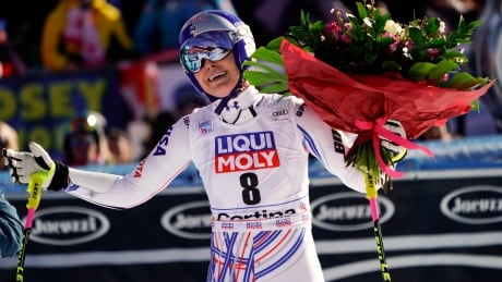American Lindsey Vonn holds a bunch of flowers she was given after completing an alpine ski, women's World Cup super-G in Cortina D'Ampezzo, Italy, on Sunday. Vonn is considering immediate retirement after not being able to finish the race. Italy Alpine Skiing World Cup