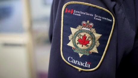 Patches are seen on the arm and shoulder of a corrections officer in the segregation unit at the Fraser Valley Institution for Women during a media tour, in Abbotsford, B.C., on Thursday October 26, 2017. AG Parole 20181120
