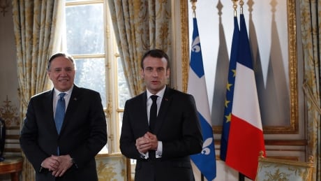 French President Emmanuel Macron speaks to the media as he greets Quebec Premier Francois Legault, left, prior to their meeting at the Elysee Palace in Paris, France. Monday, Jan. 21, 2019. (AP Photo/Rafael Yaghobzadeh Pool) France Quebec