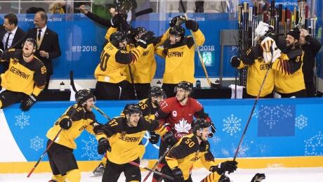 Defenceman Mat Robinson looks on as German players celebrate after defeating Canada to advance to the gold medal game at the Olympics in Pyeongchang one year ago. canada-germany-hockey-021119