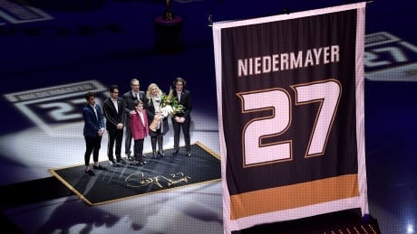 Former Ducks captain Scott Niedermayer watches along with his family as his No. 27 is raised to the rafters in Anaheim. Capitals Ducks Hockey
