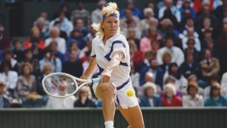 Martina Navratilova of the United States stretches to make a back hand return during the women's final match against Zina Garrison at the Wimbledon Lawn Tennis Championship in 1990. Martina-Navratilova