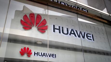 In this Jan. 29, 2019, file photo, the logos of Huawei are displayed at its retail shop window reflecting the Ministry of Foreign Affairs office in Beijing. The head of Britain's cybersecurity agency says government oversight of Huawei has proven it can flag up security problems, suggesting he doesn't think the Chinese company needs to be banned from supplying mobile networks. Ciaran Martin, the CEO of the National Cyber Security Centre, also said Wednesday, Feb. 20, 2019 that one of the conditions for maintaining good cybersecurity is having "sustainable diversity" in the telecommunications equipment supplier market. Britain Huawei