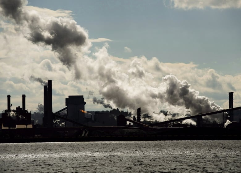 White plumes come from the stacks of steel mills, with Hamilton harbour in the foreground. 