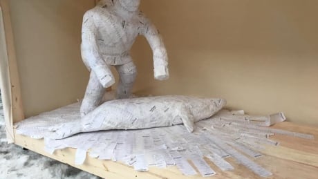 Sculpture in the Montreal Nuit Blanche of an Inuk butchering a seal. It is made out of Northmart and Northern Store receipts. Jesse Tungilik seal