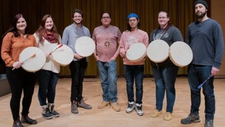 MUN School of Music Indigenous resident-thinker stands with students as part of a drum-learning session. photo-rich-blenkinsopp-michael-denny-mun-school-music