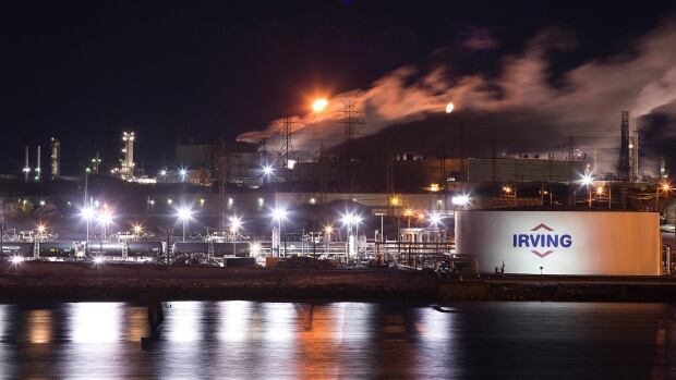 An Irving Oil storage facility and crude rail cars are photographed at the edge of Courtenay Bay on in Saint John, New Brunswick, March 9, 2014. Picture taken March 9, 2014. To match Special Report CANADA-PIPELINE/IRVINGS REUTERS/Devaan Ingraham (CANADA - Tags: BUSINESS COMMODITIES ENERGY) - GM1EA3R0OTQ01 The Irving refinery in Saint John at night