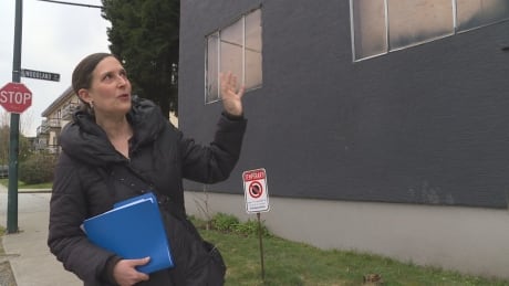Sue Robinet motions to the building she and dozens of other tenants lived until August 2018, when they were renovicted. Sue Robinet
