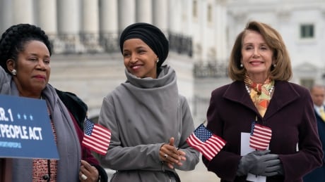 Freshman Rep. Ilhan Omar, D-Minn., center, smiles as she stands between Rep. Sheila Jackson Lee, D-Texas, left, and Speaker of the House Nancy Pelosi, D-Calif., as Democrats rally outside the Capitol ahead of passage of H.R. 1, "The For the People Act," a bill which aims to expand voting rights and strengthen ethics rules, in Washington, Friday, March 8, 2019. House Democrats are rounding the first 100 days of their new majority taking stock of their accomplishments, noting the stumbles and marking their place as a frontline of resistance to President Donald Trump. (AP Photo/J. Scott Applewhite) House Democrats 100 Days