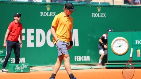 Canada's Denis Shapovalov throws his racket on the court after missing a point against Germany's Jan-Lennard Struff during the Monte-Carlo ATP Masters tournament Monday. AFP_1FN8C2