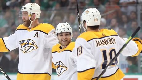 Nashville's Rocco Grimaldi, centre, celebrates his second-period goal with teammates Mattias Ekholm, left, and Calle Jarnkrok during the Predators' 3-2 win in Game 3 of their first-round series against the Dallas Stars on Monday. grimaldi-rocco-041519