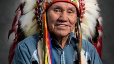 Noel Starblanket was a respected and well known Elder, Leader and traditional Knowledge Keeper in his community and the province. Here is is photographed wear the original Red Dogg headdress. Elder Noel Starblanket