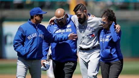 Blue Jays pitcher Matt Shoemaker is helped off the field after tearing the anterior cruciate ligament in his right knee during a rundown against the Athletics in Oakland on Saturday. Blue Jays Athletics Baseball-042019-620