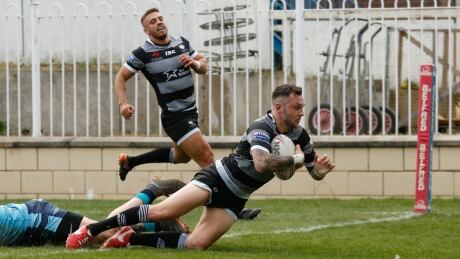Wolfpack fullback Gareth O'Brien scores a try as Toronto teammate Matty Russell watches in the Wolfpack's Betfred Championship rugby league match on Monday in Pontefract, U.K. RGL Toronto Featherstone 20190422