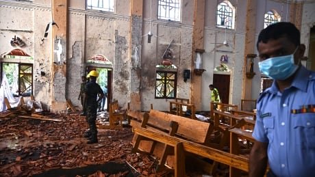 TOPSHOT - Security personnel inspect the interior of St Sebastian's Church in Negombo on April 22, 2019, a day after the church was hit in series of bomb blasts targeting churches and luxury hotels in Sri Lanka. - At least 290 are now known to have died in a series of bomb blasts that tore through churches and luxury hotels in Sri Lanka, in the worst violence to hit the island since its devastating civil war ended a decade ago. (Photo by Jewel SAMAD / AFP) (Photo credit should read JEWEL SAMAD/AFP/Getty Images) 1138611113