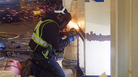 A worker makes repairs to the Spirit of British Columbia, which was damaged while trying to dock in windy conditions on Sunday, April 27, 2019. BC Ferries repairs to Spirit of British Columbia