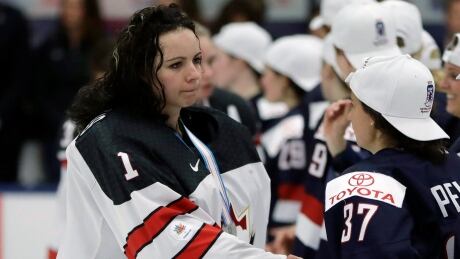 Canada goalie Shannon Szabados, left, greets United States forward Amanda Pelkey after overtime of the gold-medal game of the women's world hockey championships in 2017. On Monday, professional women's hockey players formed a union in their push toward one North American league. szabados-pelkey-052019