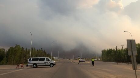 Emergency officials patrol the highway near High Level. Around 5,000 people have been evacuated from the area as wildfire threatens the town. Wildfire High Level