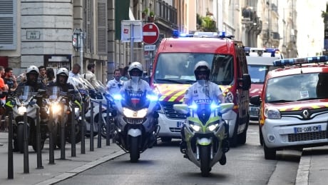 French police escort the emergency services following a suspected package bomb blast along a pedestrian street in the heart of Lyon, southeast France, the local prosecutors' office said on May 24, 2019. lyon france explosion