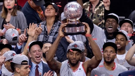 Toronto Raptors Kawhi Leonard hoists the trophy after the Raptors won theEastern Conference Final against the Milwaukee Bucks Toronto on Saturday, May 25, 2019. THE CANADIAN PRESS/Frank Gunn BKN Bucks Raptors 20190523