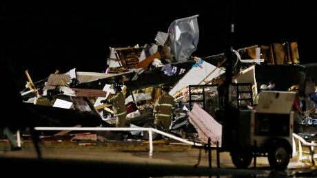 Emergency workers search through debris from a mobile home park, Sunday, May 26, 2019, in El Reno, Ok., following a likely tornado touchdown late Saturday night. (AP Photo/Sue Ogrocki) US Severe Weather