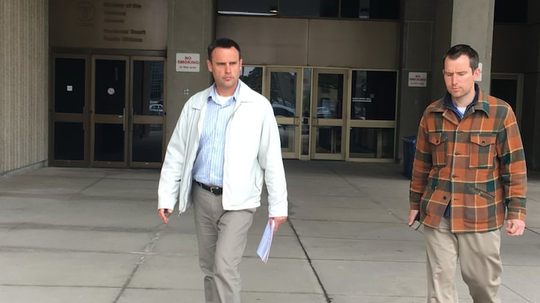 Steven Ravbar, 50, and Matthew Carapella, 32, leave the Ontario Court of Justice on Monday after making a brief appearance on mischief charges. 