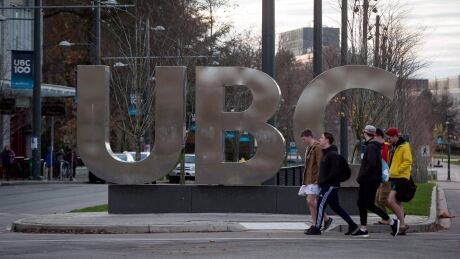 People walk past large letters spelling out UBC at the University of British Columbia in Vancouver, B.C., on November 22, 2015. Former students and faculty involved in the University of British Columbia's investigation of its creative writing chair say the allegations against him included sexual harassment, bullying and threats. Professor Misconduct 20160625