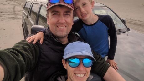 Michael Coyle, 49 and his partner, Sylvia Fuller, and their son, Eamon, pose on a beach. Michael Coyle and family