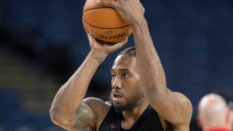 Toronto Raptors' Kawhi Leonard shoots at practice on Wednesday. Leonard took a big-picture approach when asked about the pressure of the NBA Finals. leonard-kawhi-061219