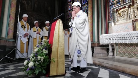 The Archbishop of Paris Michel Aupetit leads the first mass in a side chapel two months to the day after a devastating fire engulfed the Notre-Dame de Paris cathedral on June 15, 2019, in Paris. - The Notre-Dame cathedral in Paris will host its first mass on June 15, 2019, exactly two months after the devastating blaze that shocked France and the world. For safety reasons, the mass led by Archbishop of Paris Michel Aupetit will be celebrated on a very small scale. Worshippers will be expected to don hard hats but priests will be wearing their ceremonial garb. (Photo by Karine PERRET / POOL / AFP) (Photo credit should read KARINE PERRET/AFP/Getty Images) 1150162186