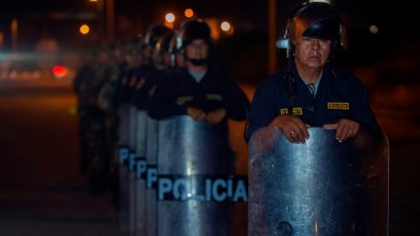 Peruvian police close the Pan American highway north of the city of Tumbes, close to the border with Ecuador, at midnight on June 14, 2019, in order to stop the flow of undocumented Venezuelan nationals. - Following President Martin Vizcarra's announcement last week alleging security reasons, the Peruvian government announced that Venezuelans will need a humanitarian visa, as well as a passport, as off June 15 to enter Peru, where there are already more than 800,000 migrants from that country. (Photo by Cris BOURONCLE / AFP) (Photo credit should read CRIS BOURONCLE/AFP/Getty Images) 1150143339