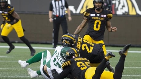 Saskatchewan Roughriders quarterback Zach Collar is hit late by Hamilton Tiger-Cats' Simoni Lawrence after Collaros was downed by Tiger-Cats' Julian Howsare during first half CFL football game action in Hamilton on June 13, 2019. The CFL suspended Hamilton Tiger-Cats linebacker Simoni Lawrence for two games Monday for hitting Saskatchewan Roughriders quarterback Zach Collaros in the head during the league's regular-season opener Thursday night. FBO CFL Suspension 20190617