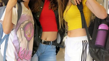 In this Sept. 7, 2018 photo, students socialize at Grant High School in Portland, Ore., after school let out. Portland Public Schools relaxed its dress code in 2016 after student complaints that the rules unfairly targeted female students and sexualized their fashion choices. Relaxing School Dress Codes