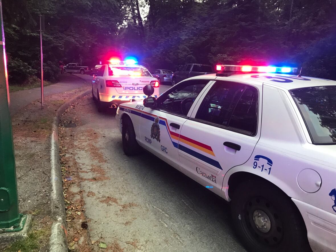 Two RCMP vehicles flash their lights